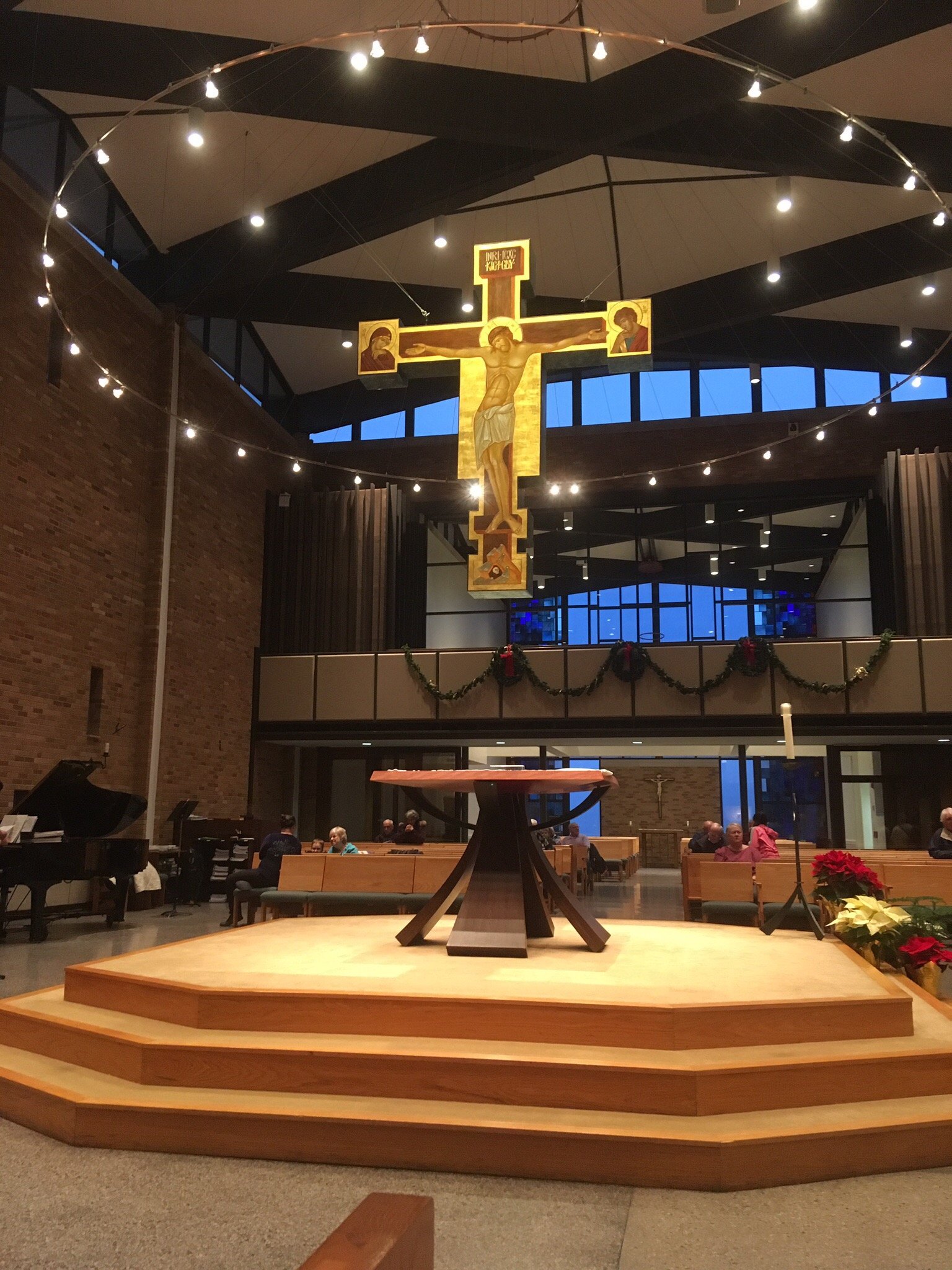 Sanctuary of St. Thomas Aquinas Catholic Church, with the altar and large crucifix.