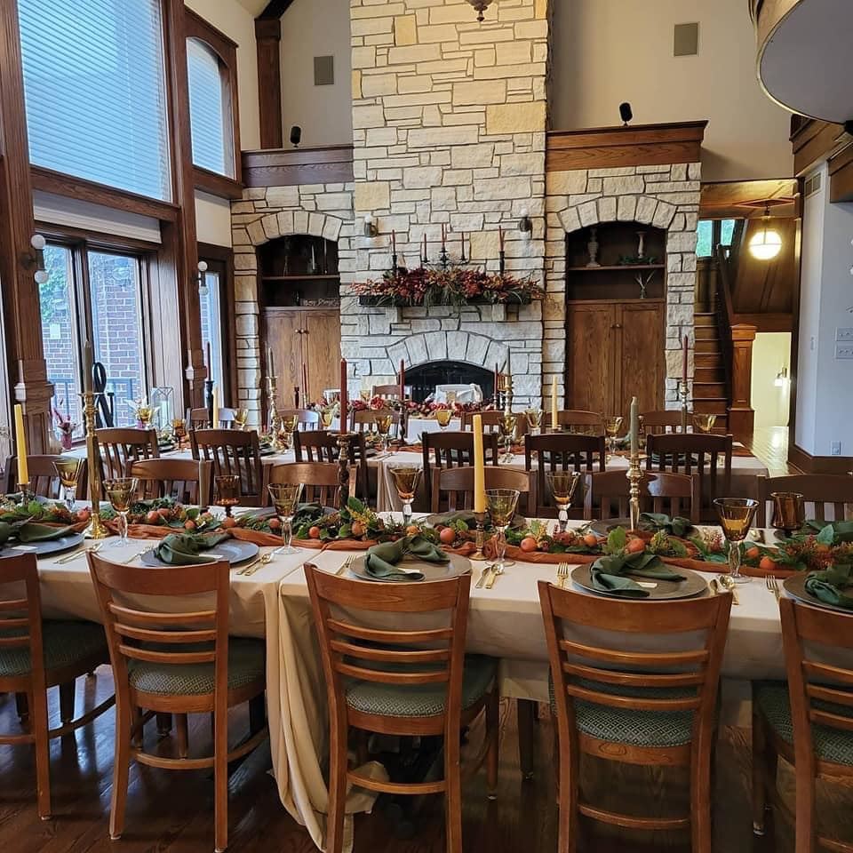 Dining room at Raspberry Hill, set beside the stone fireplace.