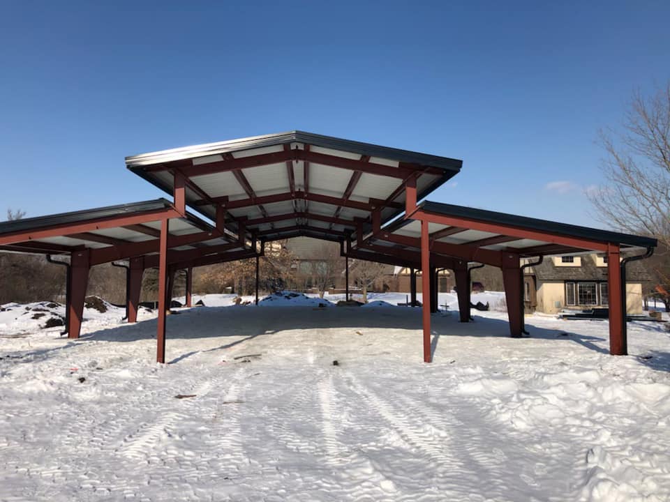 Open-air pavilion at Raspberry Hill in Ames with a snow-covered lawn.